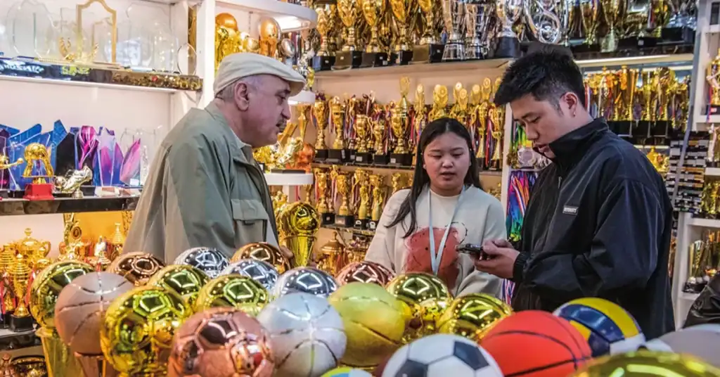 Buyer sourcing football trophies and sports merchandise in Yiwu Market China