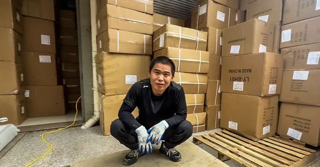 Yiwu inspection report warehouse check with an inspector beside stacked product cartons