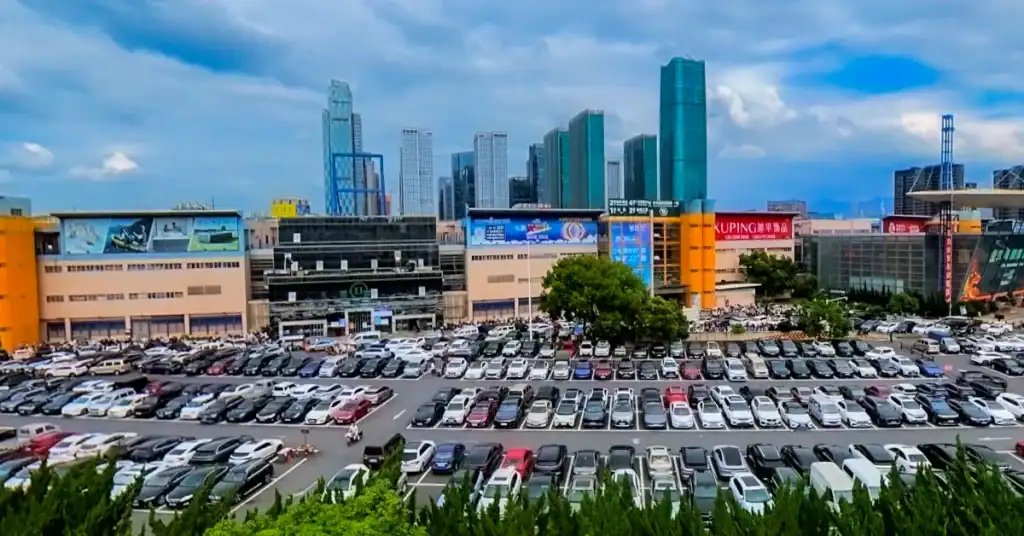 Remote sourcing vs visiting Yiwu Market illustrated by the market complex and surrounding business district
