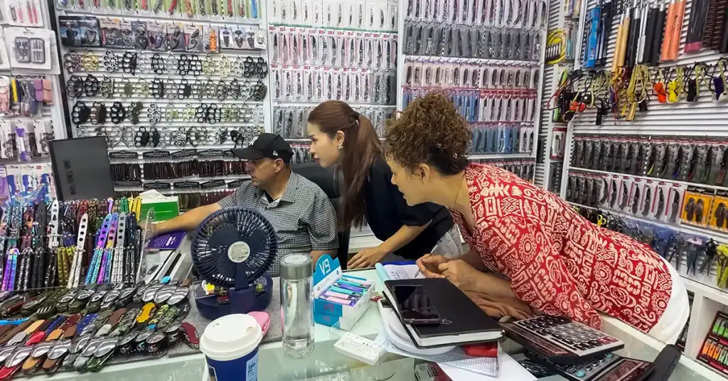 Yiwu Inspection Before Balance Payment as buyers review stationery products with a supplier at Yiwu Market.